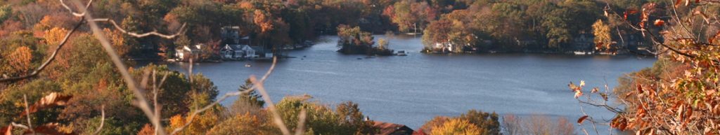 Lake surrounded by trees and homes in Byram Township